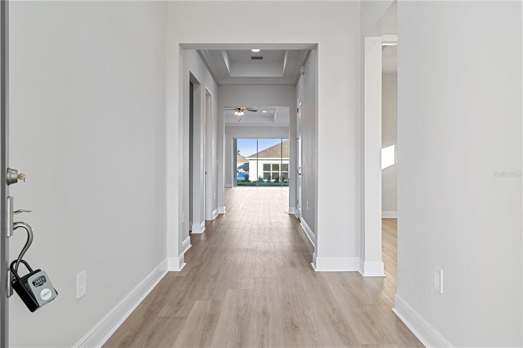 7851 Stoney Bay Loop Kissimmee, FL 34747 - Photo 3 of 33 a view of a hallway with wooden floor and a bathroom