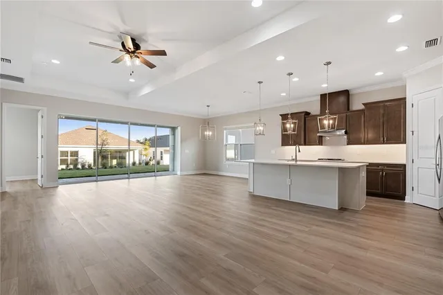 a large kitchen with stainless steel appliances kitchen island granite countertop a large cabinets a sink and a stove