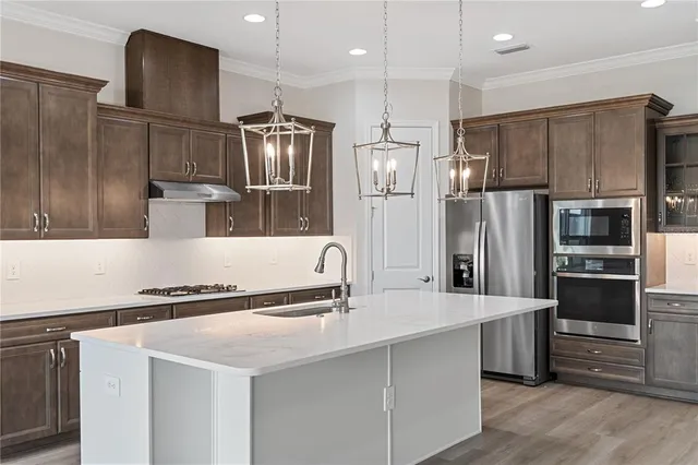 a kitchen with granite countertop a refrigerator and a sink