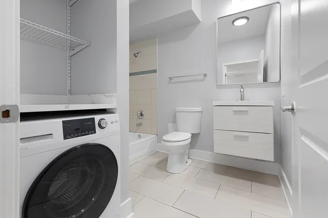 a bathroom with a sink and a washer dryer