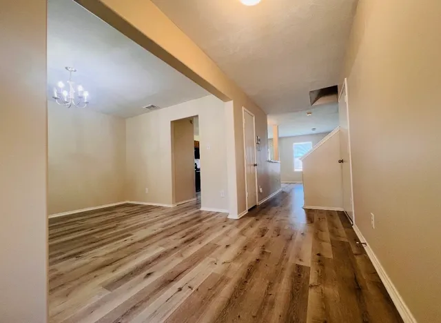 a view of a hallway with a chandelier