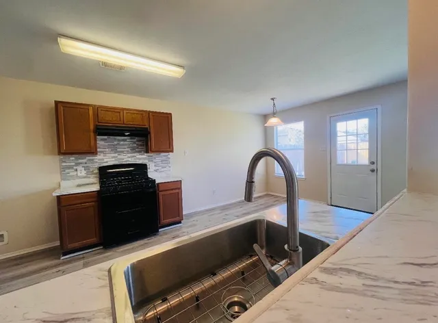 a kitchen with a stove and a sink