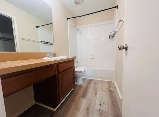 a bathroom with a sink a toilet a shower and a mirror