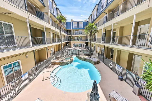 a view of a swimming pool with outdoor seating