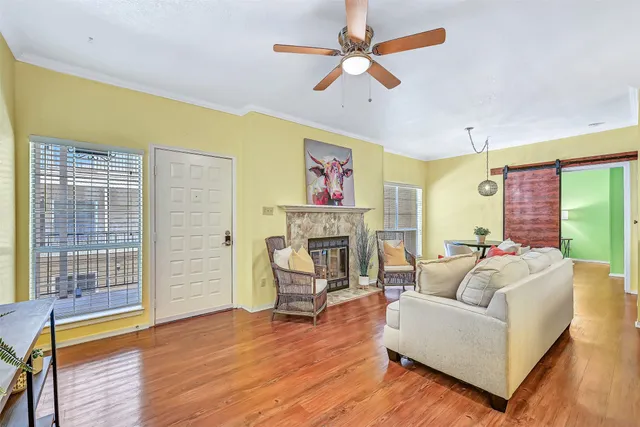 a living room with fireplace furniture and a wooden floor