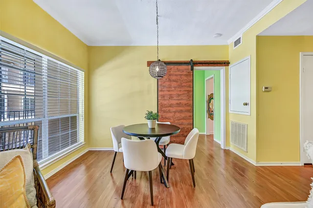 a view of a dining room with furniture and wooden floor