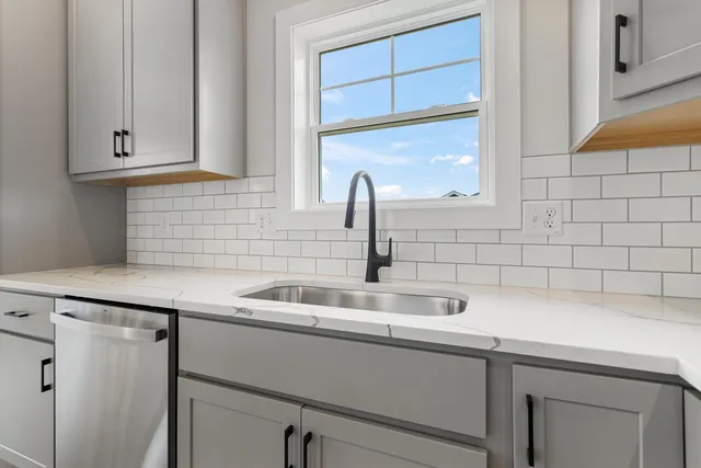 a kitchen with a sink and cabinets