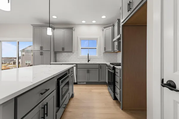 a kitchen with a sink stove and refrigerator