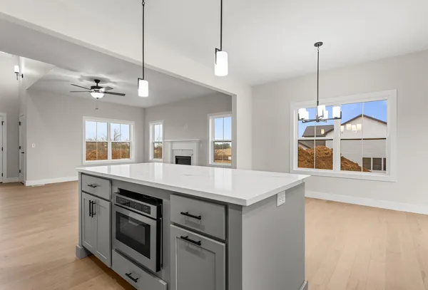 a kitchen with a stove and a chandelier
