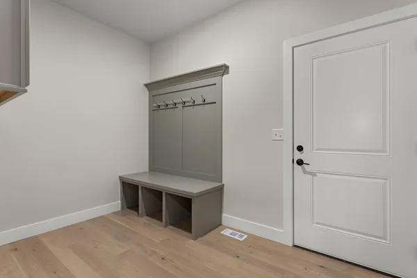 a view of an empty room with wooden floor