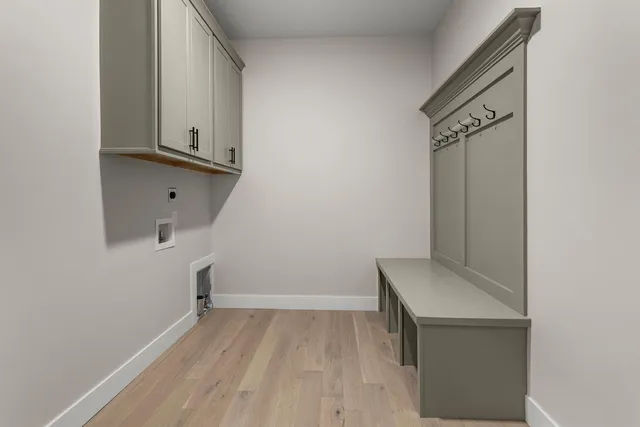 a view of storage and utility room with wooden floor