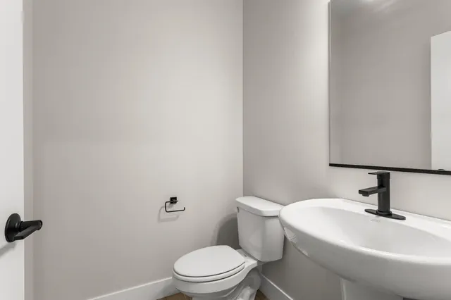 a white toilet sitting next to a bathroom sink