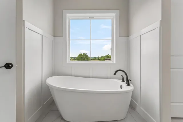 a white bath tub sitting next to a window