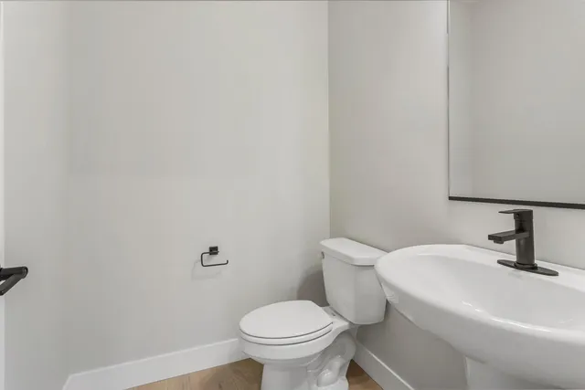 a white toilet sitting next to a bathroom sink