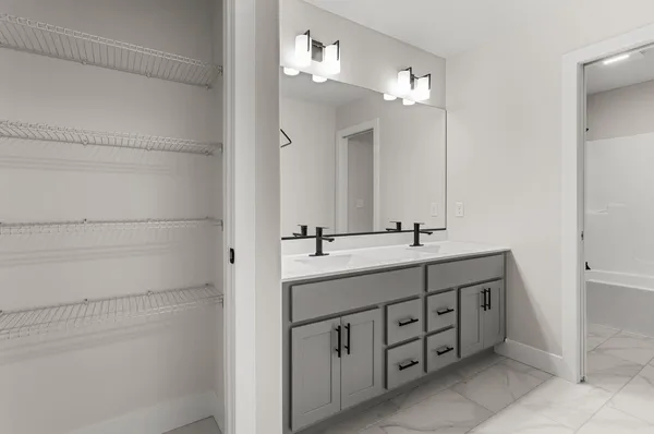 a bathroom with a double vanity sink and a mirror