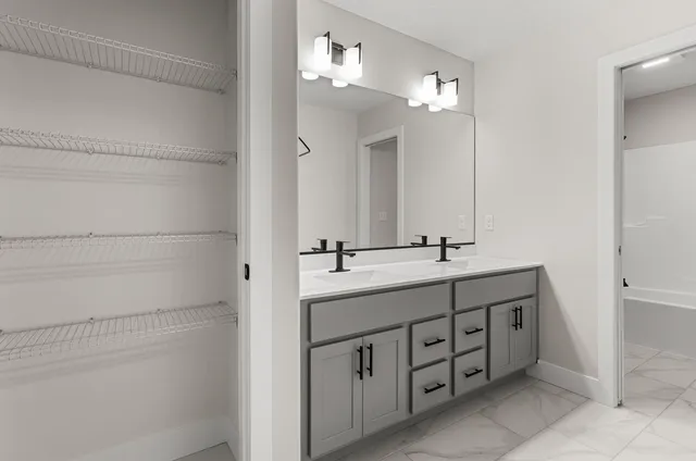 a bathroom with a double vanity sink and a mirror