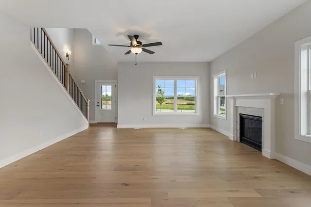 a view of an empty room with exposed radiator and fireplace
