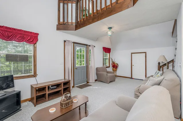 a living room with furniture gym equipment and a window