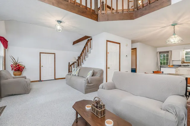 a living room with furniture and a chandelier