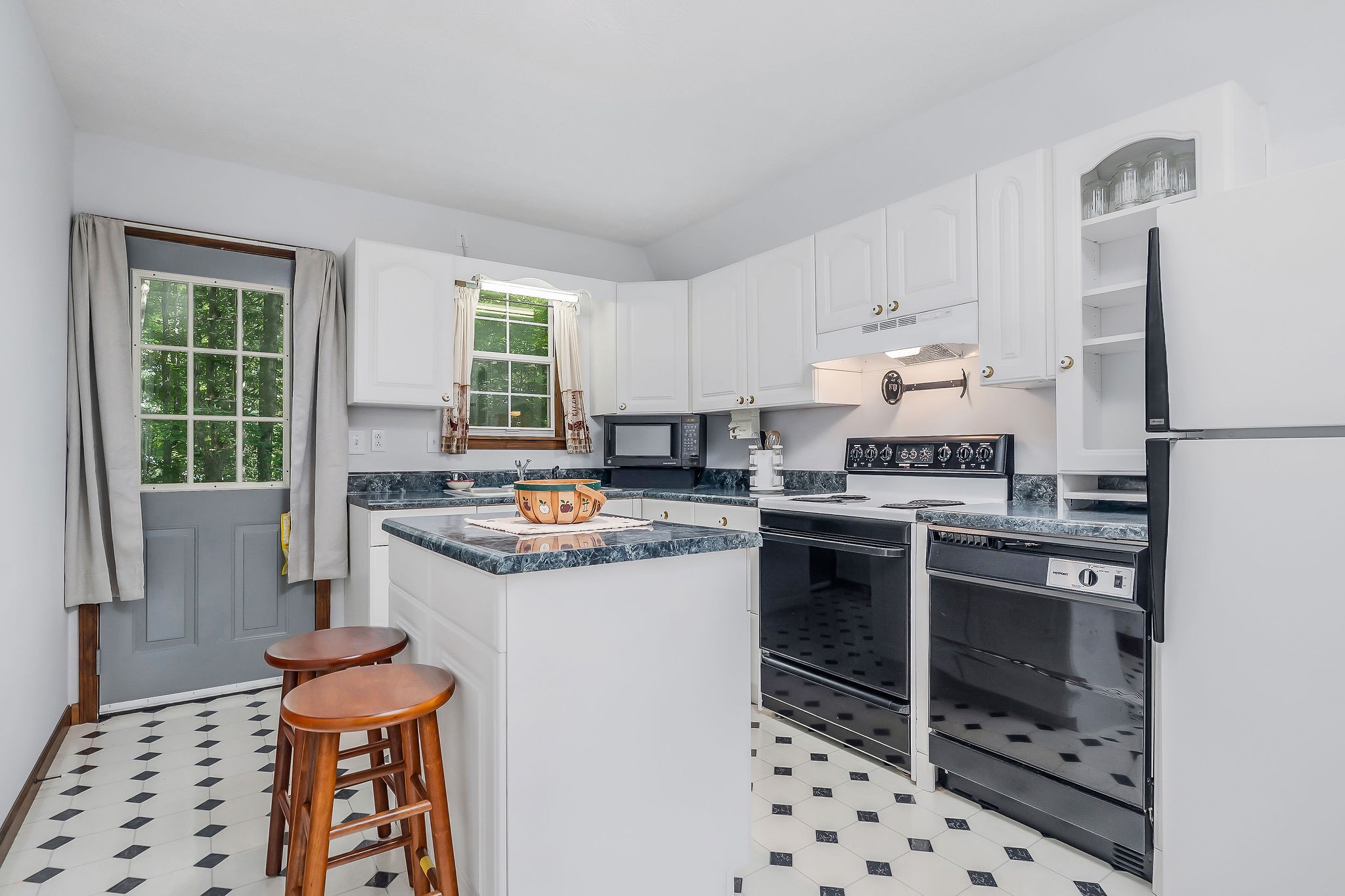 308 Cosby Parris Road Byrdstown, TN 38549 - Photo 15 of 32 a kitchen with granite countertop a stove a sink and a refrigerator