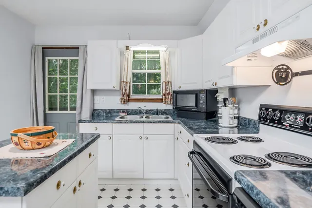 a kitchen with stainless steel appliances granite countertop a sink stove and cabinets