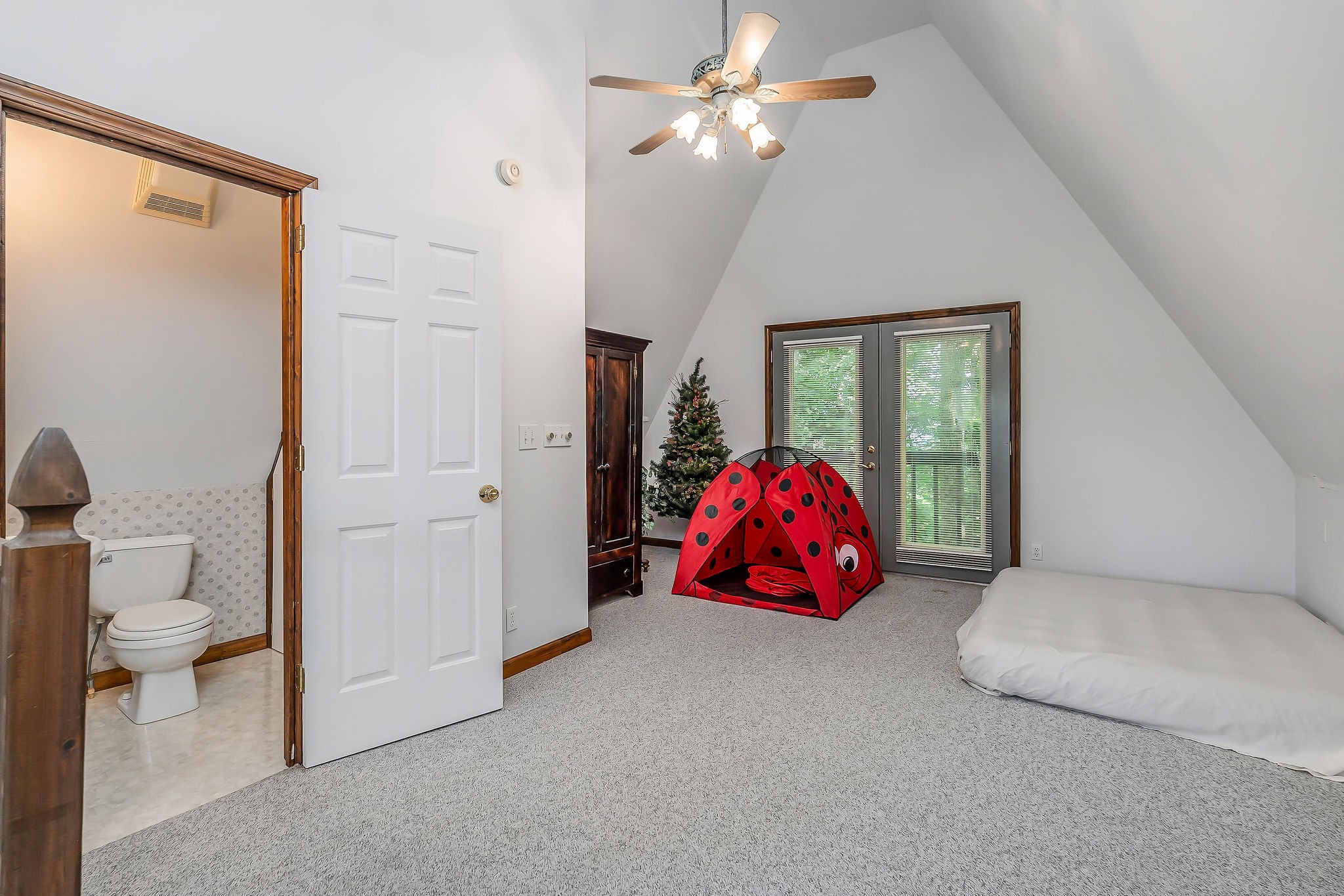 308 Cosby Parris Road Byrdstown, TN 38549 - Photo 23 of 32 a bedroom with a bed and a chandelier