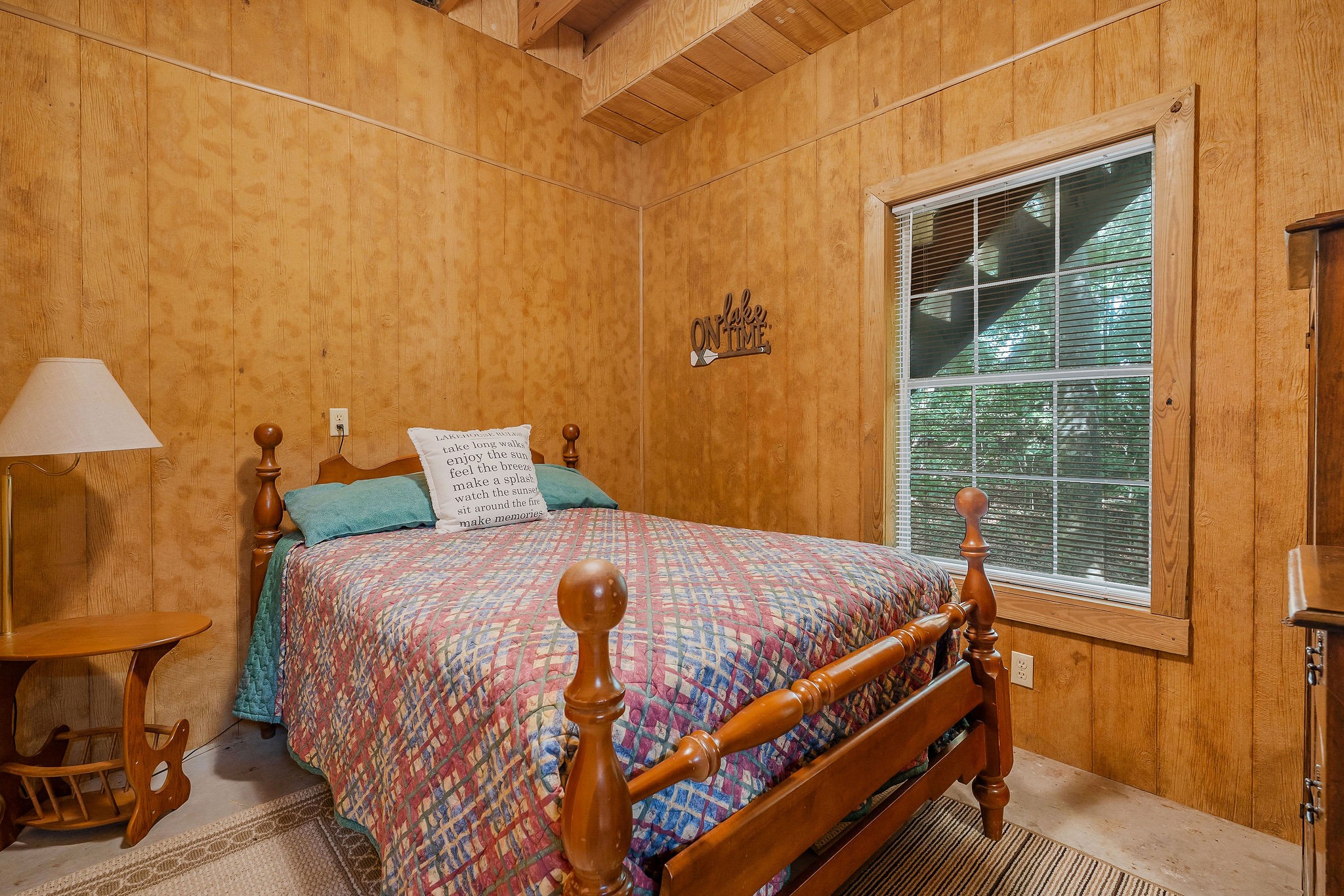 308 Cosby Parris Road Byrdstown, TN 38549 - Photo 28 of 32 a bed sitting in a bedroom next to a window