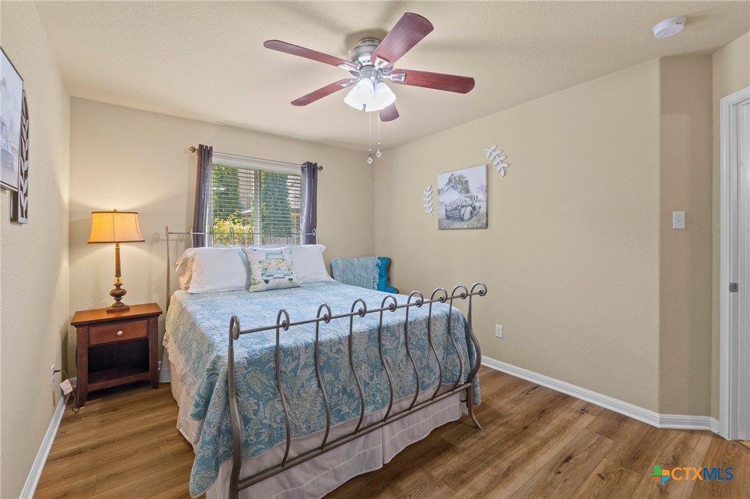 20525 Jackies Ranch Boulevard Pflugerville, TX 78660 - Photo 17 of 30 Bedroom featuring ceiling fan and wood look finished floors. Roomy closet.