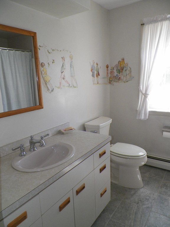 7 Homestead Road Bourne, MA 02562 - Photo 14 of 26 a bathroom with a granite countertop sink a toilet and a mirror
