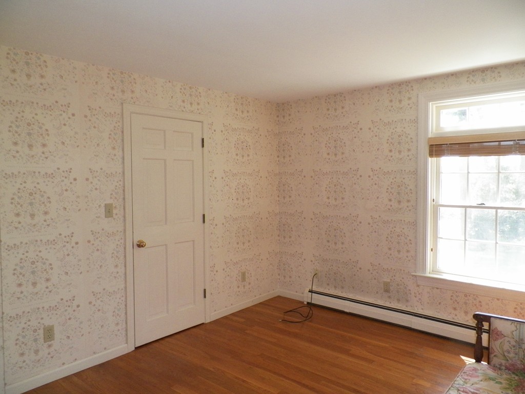 7 Homestead Road Bourne, MA 02562 - Photo 17 of 26 a view of an empty room with wooden floor and a window
