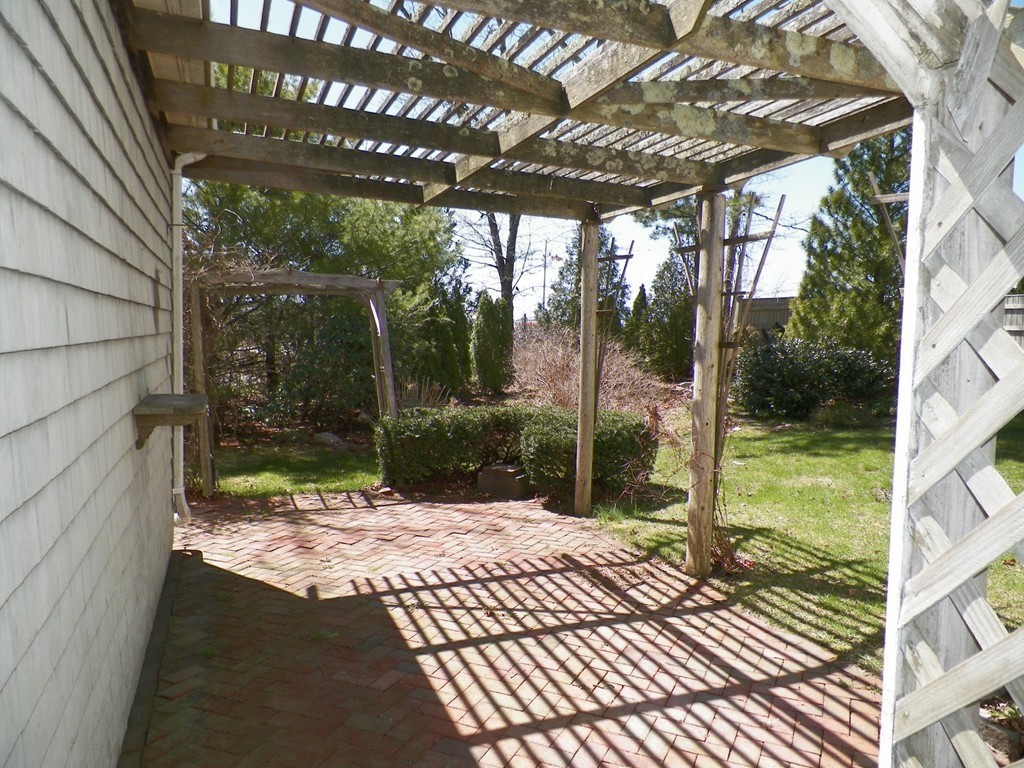 7 Homestead Road Bourne, MA 02562 - Photo 4 of 26 a view of backyard with tub and porch