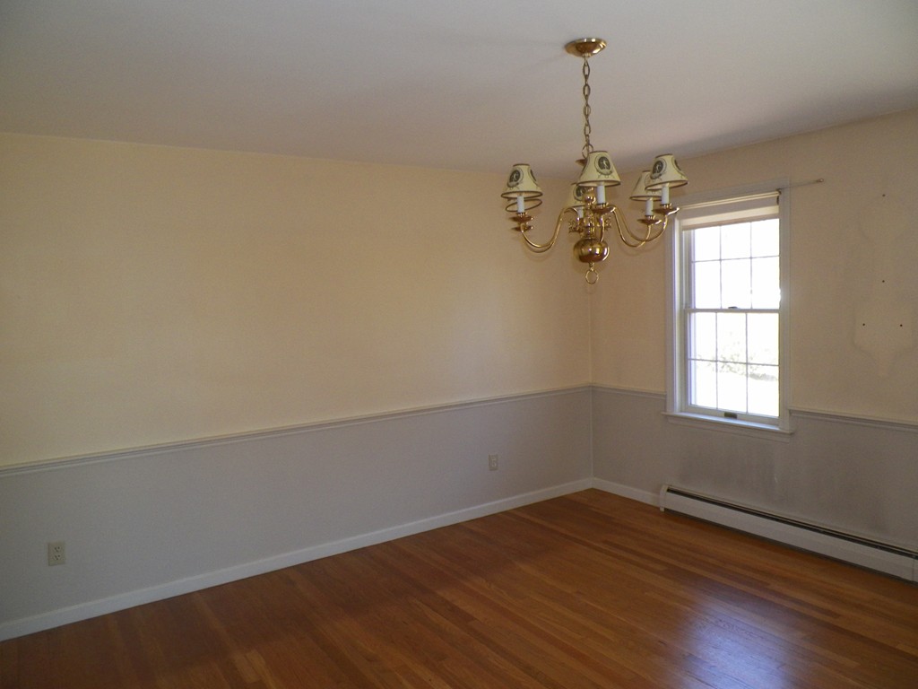 7 Homestead Road Bourne, MA 02562 - Photo 9 of 26 an empty room with wooden floor and windows