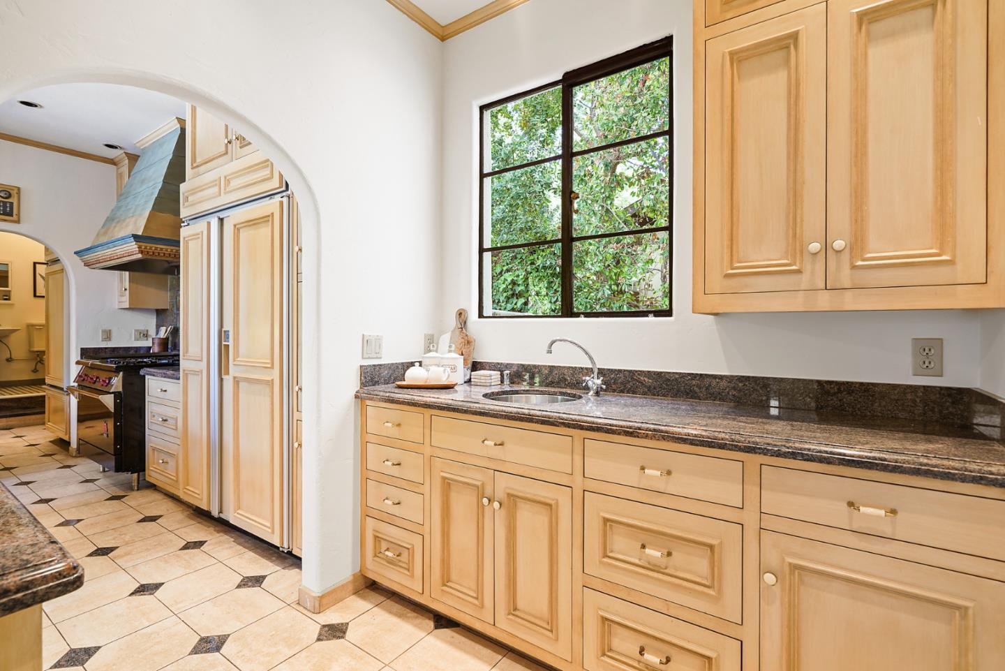 401 Parrott Drive San Mateo, CA 94402 - Photo 23 of 68 a kitchen with granite countertop a sink window and cabinets