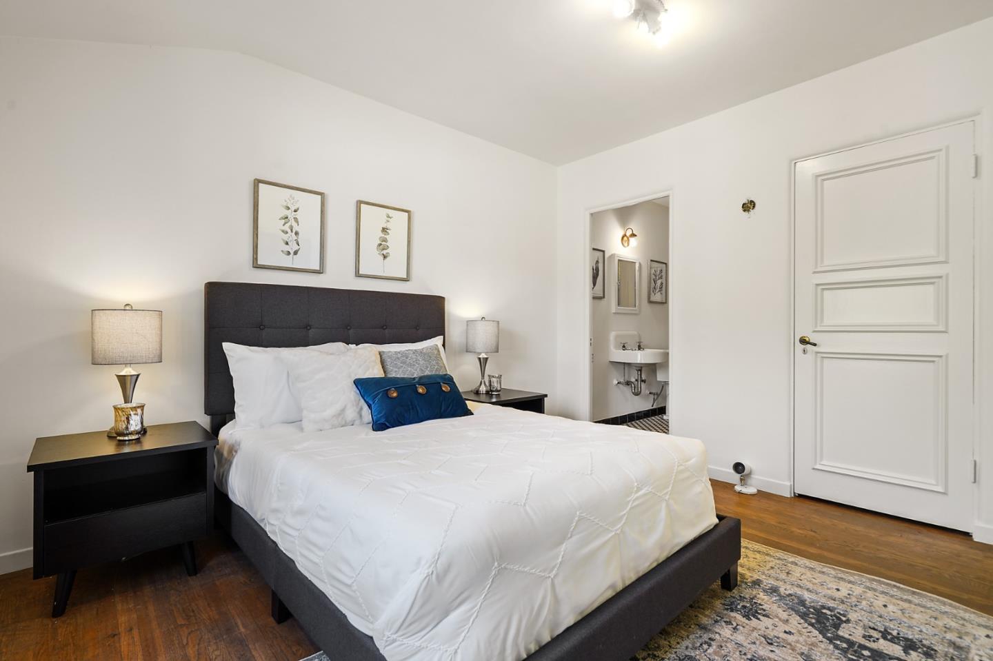 401 Parrott Drive San Mateo, CA 94402 - Photo 28 of 68 a bedroom with a bed and a lamp