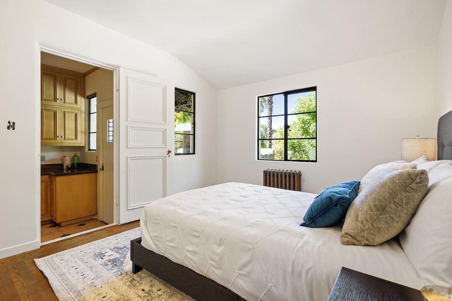 401 Parrott Drive San Mateo, CA 94402 - Photo 29 of 68 a bedroom with a bed and wooden floor