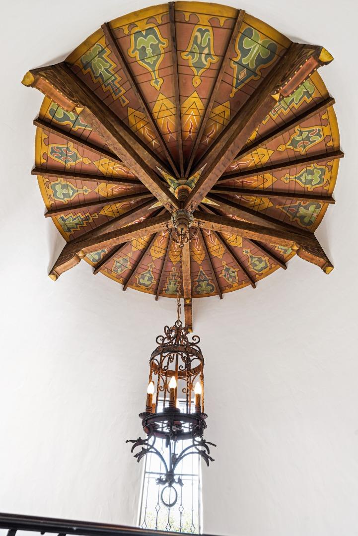 401 Parrott Drive San Mateo, CA 94402 - Photo 32 of 68 a room with a chandelier fan and a black umbrella