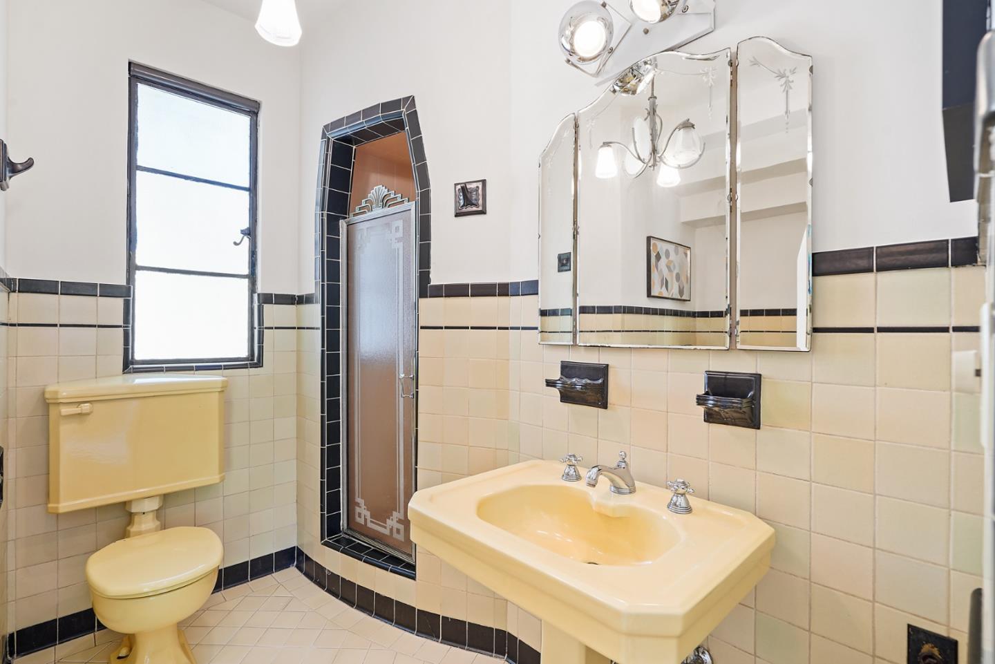 401 Parrott Drive San Mateo, CA 94402 - Photo 42 of 68 a bathroom with a sink a toilet and mirror