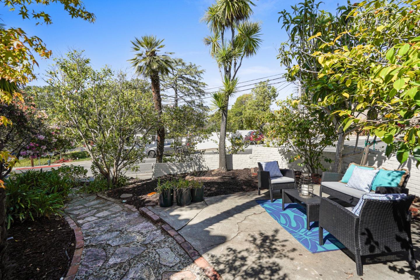 401 Parrott Drive San Mateo, CA 94402 - Photo 63 of 68 a view of a backyard with couches plants and large trees