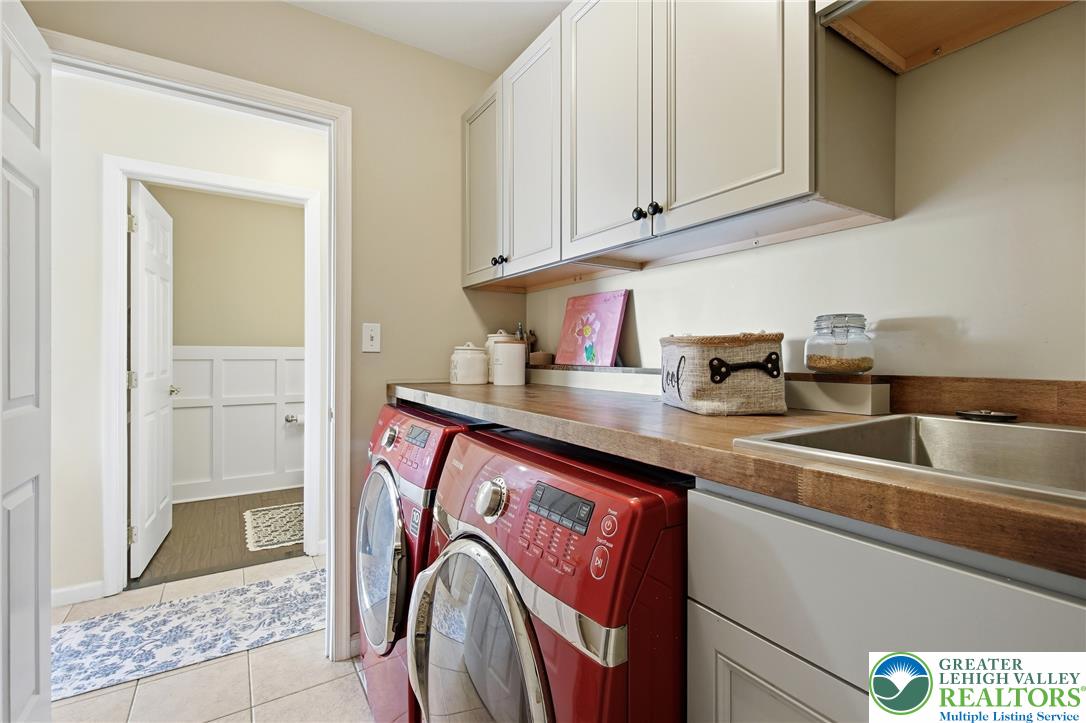 115 West Butternut Road Hellertown, PA 18055 - Photo 31 of 97 Functional laundry room featuring a utility sink and elegant wood countertops.