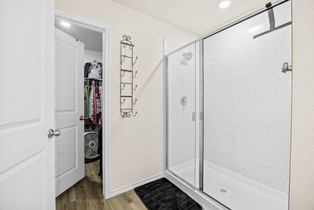 822 Ramble Road Lavon, TX 75166 - Photo 27 of 35 Spacious shower enclosure with clear glass doors and a bright interior