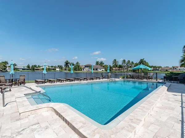 a view of a swimming pool and lounge chairs
