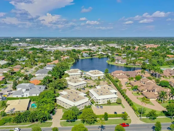 an aerial view of residential building and lake