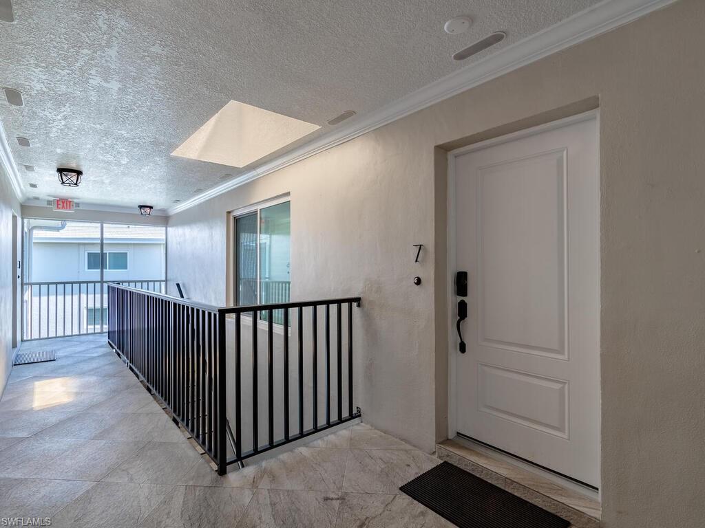 4180 Crayton Road, Unit E7 Naples, FL 34103 - Photo 3 of 35 a view of a hallway