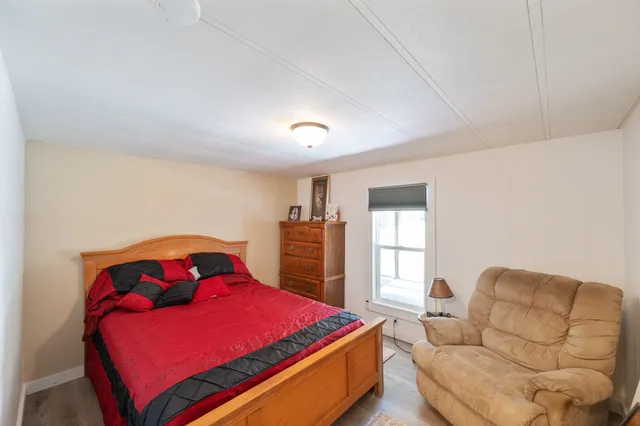 a bedroom with a bed and window