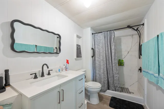 a bathroom with a sink toilet and shower
