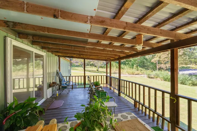 a view of a porch with wooden floor