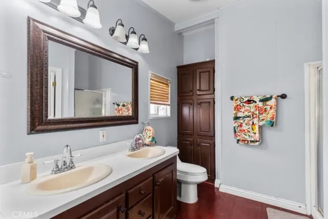 a bathroom with a toilet sink and mirror