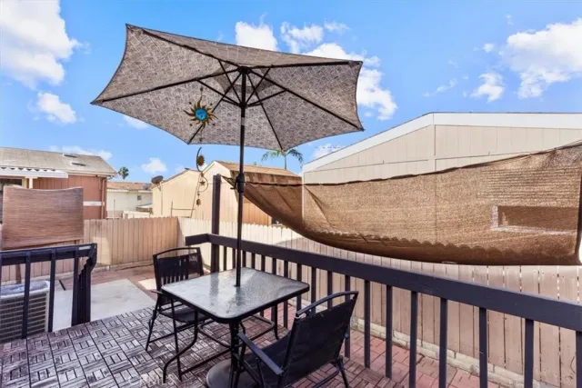 a balcony with a table and chairs
