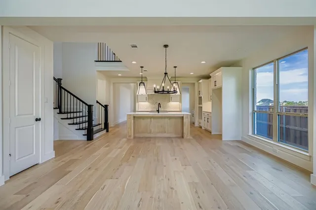 a view of a kitchen with wooden floor and a kitchen