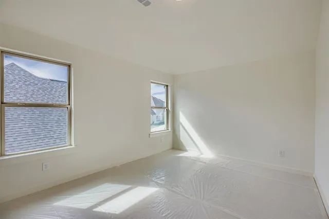 a view of an empty room with windows